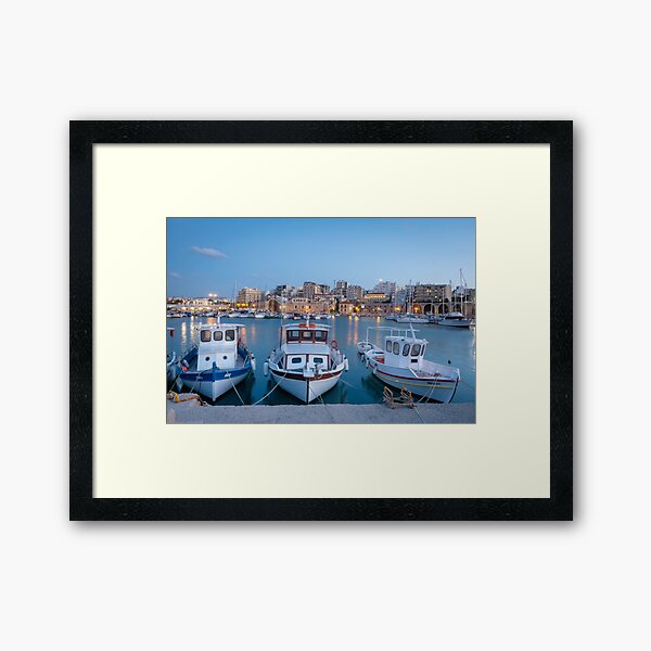 Boats docked at dusk in Heraklion, Greece. Framed Art Print
