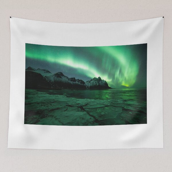 Item preview, Northern lights above Vestrahorn mountain in Stokksnes, Iceland with ice in the foreground designed and sold by michieldros.