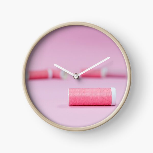 Pink sewing threads on a pink background Clock