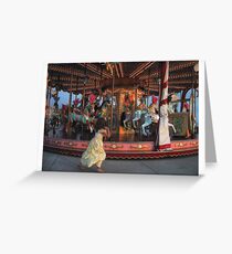 Girl plays with carousel Greeting Card