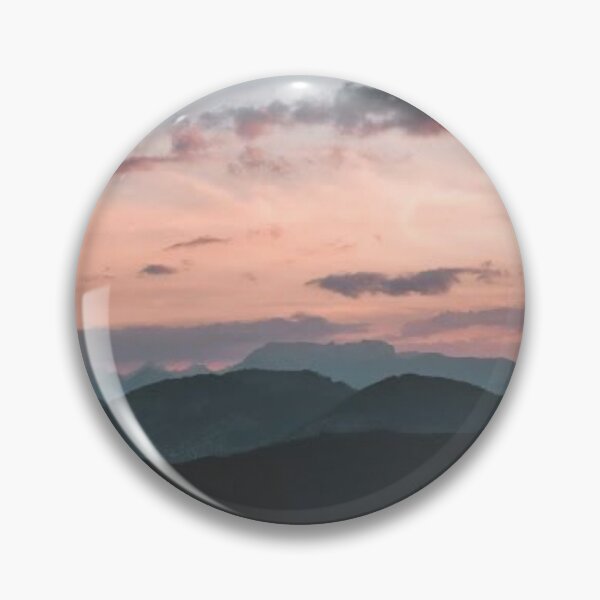 Item preview, pink cloudy sky looking over dark green trees and mountains protective face mask designed and sold by danikameb.