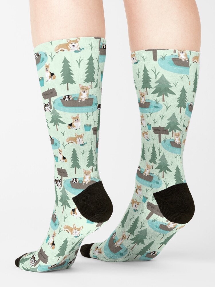 Alternate view of Corgis are fishing in the forest lake Socks