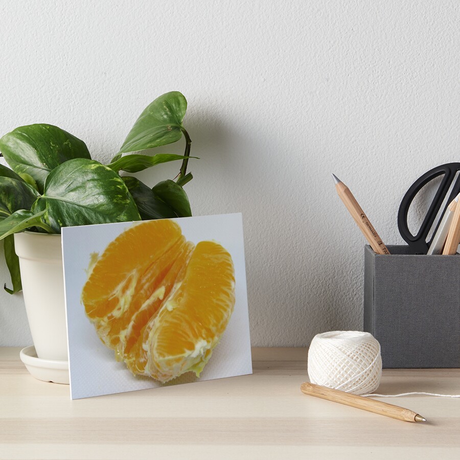 Half of orange fruit with juice drop dripping white paper Art Board Print