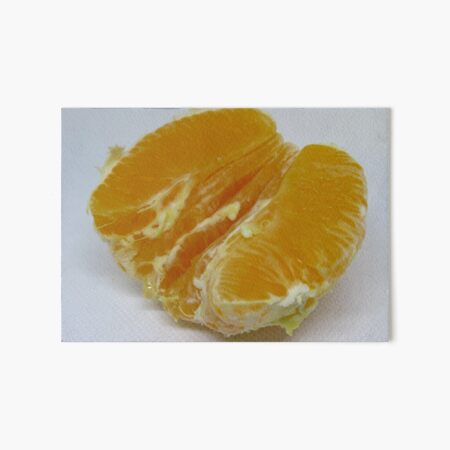 Half of orange fruit with juice drop dripping white paper Art Board Print