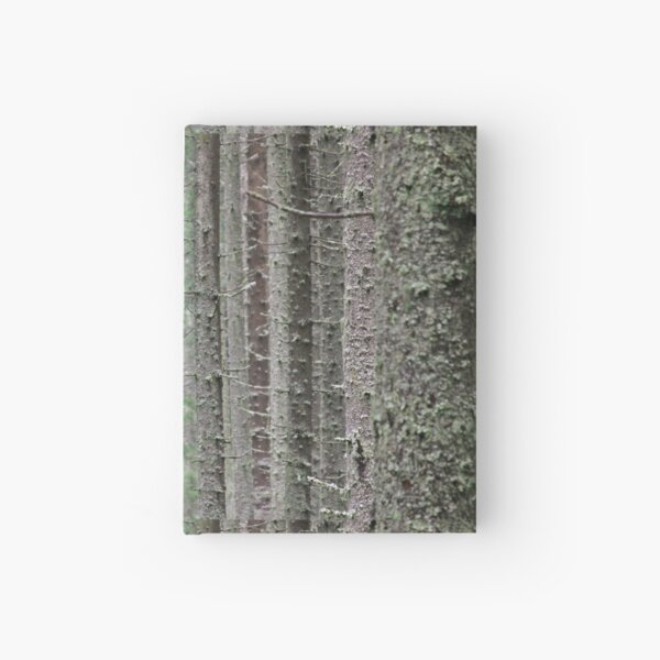 Pine tree trunks covered in moss Hardcover Journal