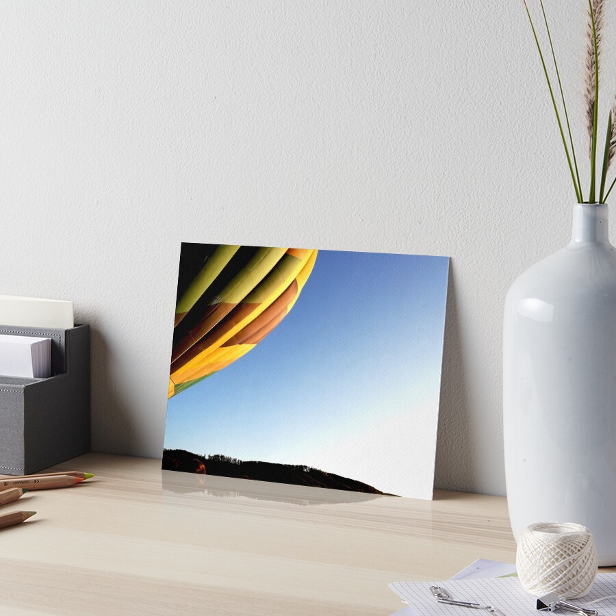 Colorful hot air balloon rising, sky without clouds, wonderful landscape Art Board Print