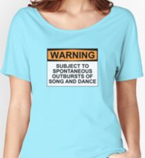 WARNING: SUBJECT TO SPONTANEOUS OUTBURSTS OF SONG AND DANCE Women's Relaxed Fit T-Shirt
