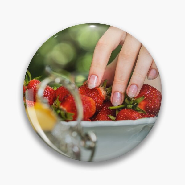 Item preview, Beautiful female hand with manicure takes a strawberry from a plate.  designed and sold by Alexander Sorokopud.