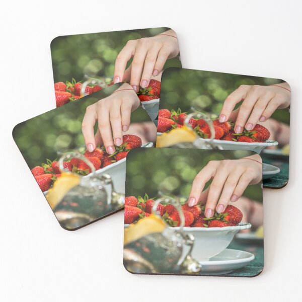 Item preview, Beautiful female hand with manicure takes a strawberry from a plate.  designed and sold by Alexander Sorokopud.