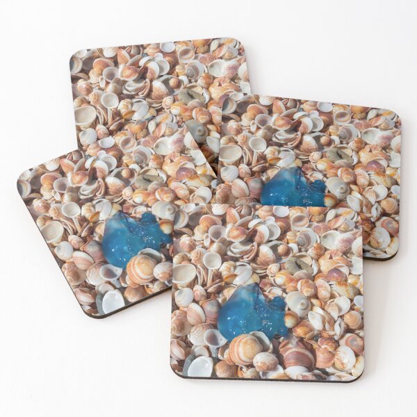 Item preview, Top view of the blue jellyfish close-up on multi colored sea shells on the Mediterranean coast designed and sold by EG Creativity Art.