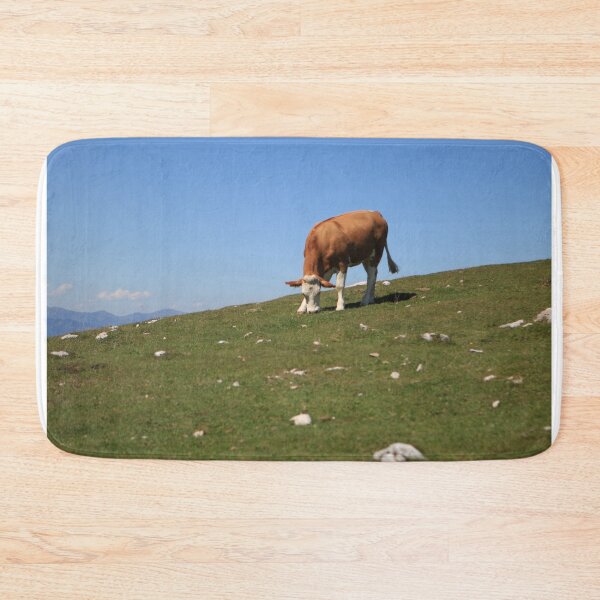 Item preview, Cow grazes in a meadow on a mountain designed and sold by Hannah Schmid.