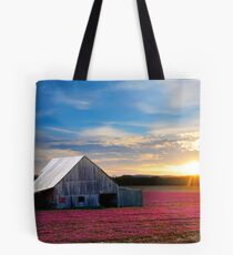 Spring growth of flowers and Barn at sundown Tote Bag