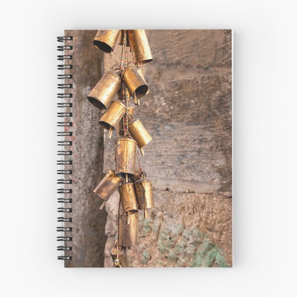 Item preview, A bunch of copper bells on a multi-colored thread close-up on a stone wall background designed and sold by EG Creativity Art.