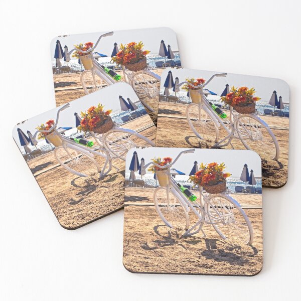 Item preview, White bicycle decorated with baskets of flowers parked on golden beach with sea and umbrellas background designed and sold by Flavio Vieri.