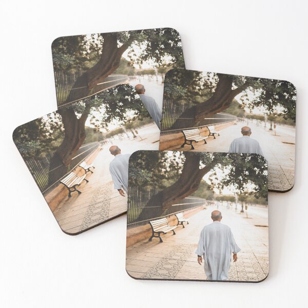 Item preview, muslim old man walking in the colorful streets of marrakech during sunset with a beautiful trees scape designed and sold by Morocco Marrakech Photo Prints.