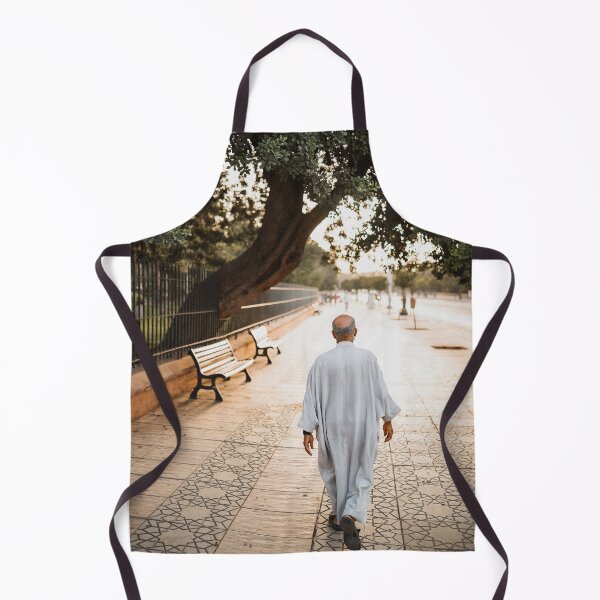 Item preview, muslim old man walking in the colorful streets of marrakech during sunset with a beautiful trees scape designed and sold by Morocco Marrakech Photo Prints.