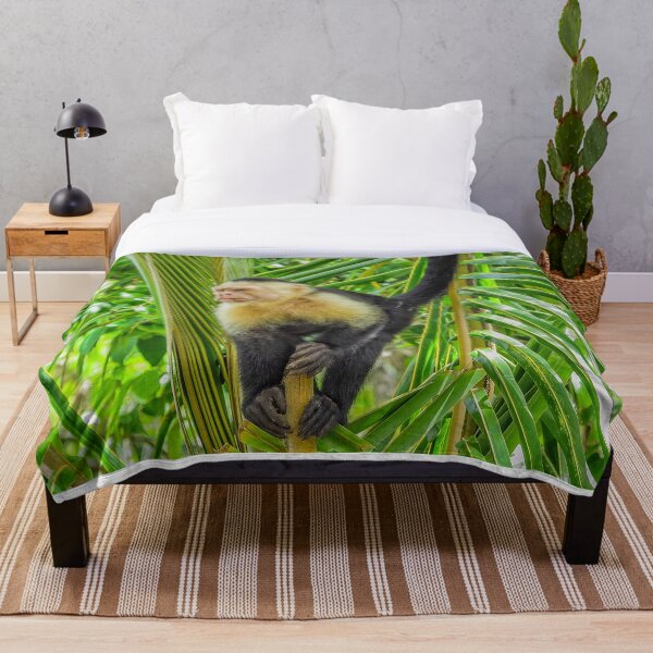 White faced monkey in a tree Throw Blanket