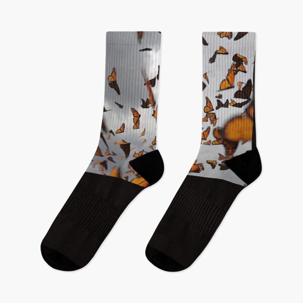 Item preview, group of monarch butterflies, Danaus plexippus swarm in front of dark clouds designed and sold by DottedYeti.