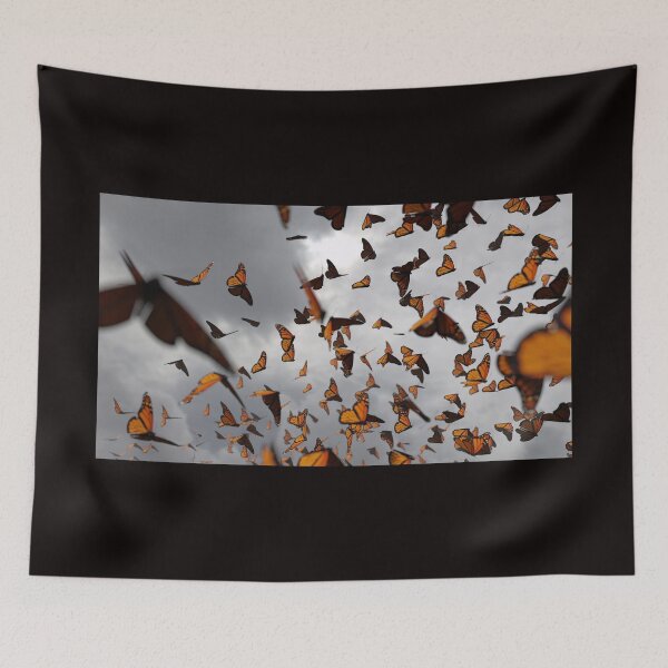 Item preview, group of monarch butterflies, Danaus plexippus swarm in front of dark clouds designed and sold by DottedYeti.