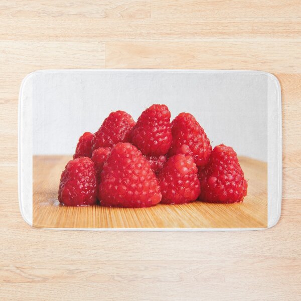 Item preview, Fresh red raspberry fruits stacked on wooden board designed and sold by krisgreenwood.