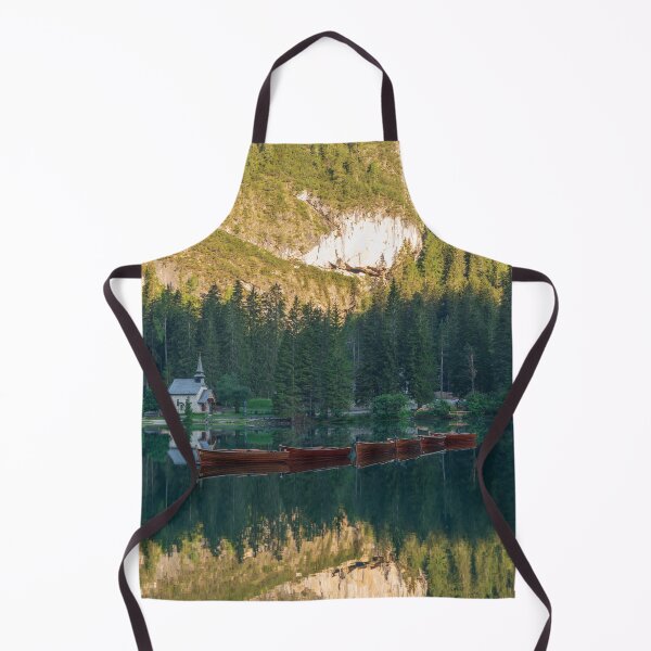 Item preview, Row of wooden boats in front of a church reflected in the water designed and sold by brambillasimone.
