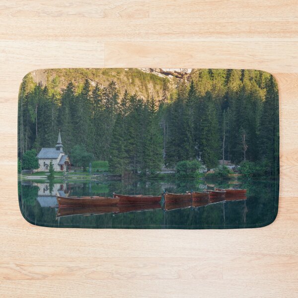 Item preview, Row of wooden boats in front of a church reflected in the water designed and sold by brambillasimone.