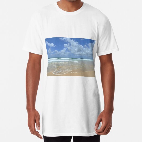 Gentle waves on a sandy beach, against a blue sky. Long T-Shirt
