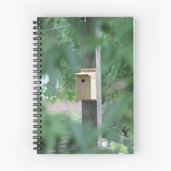 Item preview, Wooden bird house seen through trees designed and sold by stina-bee.
