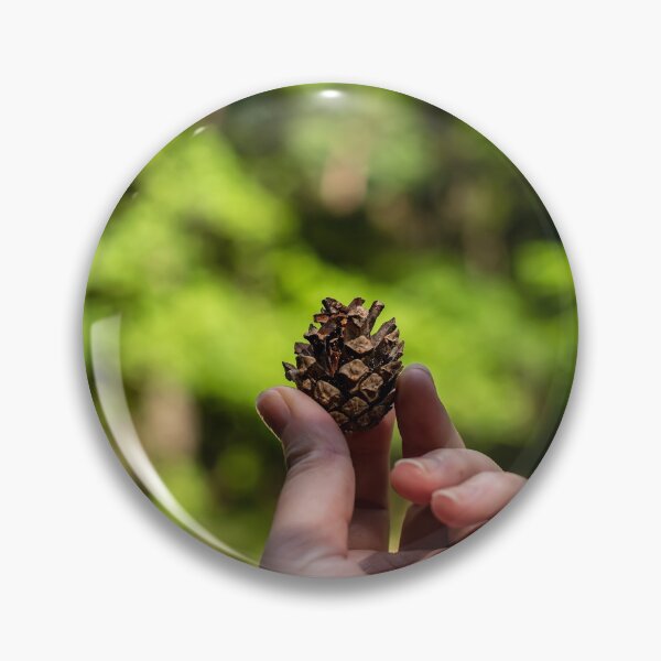 Item preview, Hand holding pine cone designed and sold by lena-maximova.