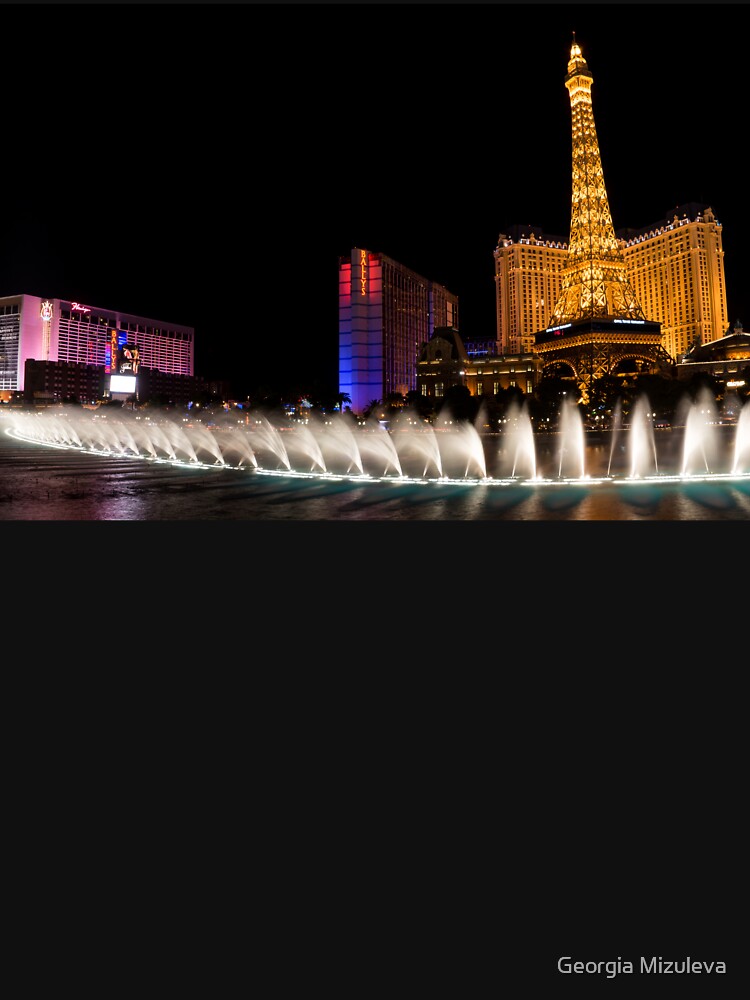 View across lake to replica Eiffel Tower at the Paris Hotel and Casino,  Bellagio fountains in