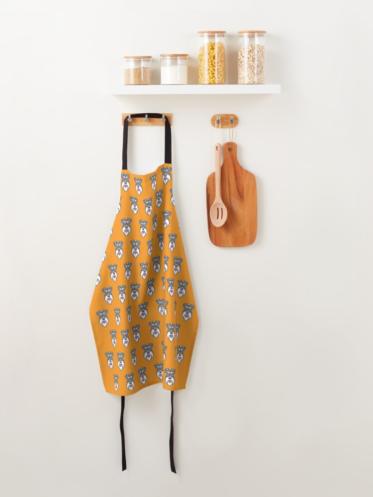 Apron, Salt & Pepper schnauzer pattern on orange background designed and sold by Buzby Bluebeard