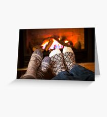 Feet warming by fireplace Greeting Card