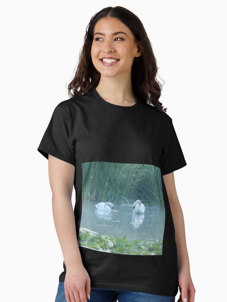 Thumbnail 1 of 7, Classic T-Shirt, Two white swans on the morning lake designed and sold by steppeland.