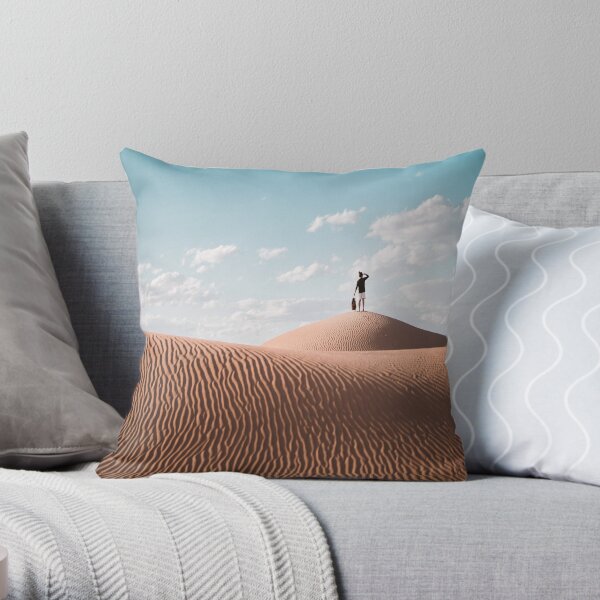 Pillow of a person standing on brown sand under a blue sky Throw Pillow