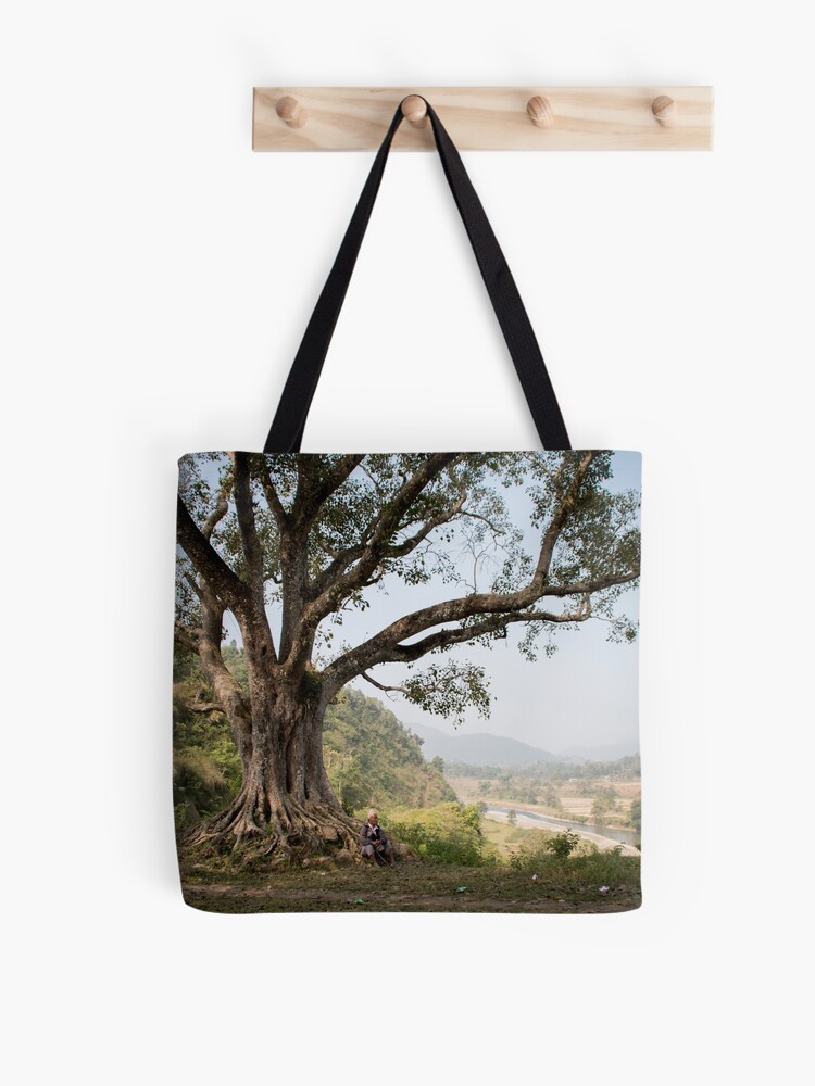 Thumbnail 1 of 2, Tote Bag, Nepali man sitting under a tree designed and sold by missatgerebut.