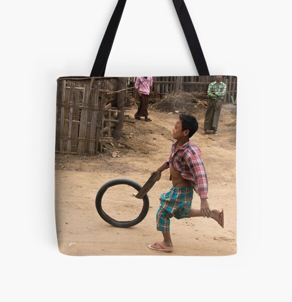 A Child Playing With A Wheel in Myanmar All Over Print Tote Bag