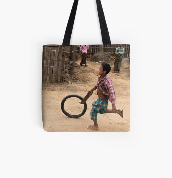 A Child Playing With A Wheel in Myanmar All Over Print Tote Bag