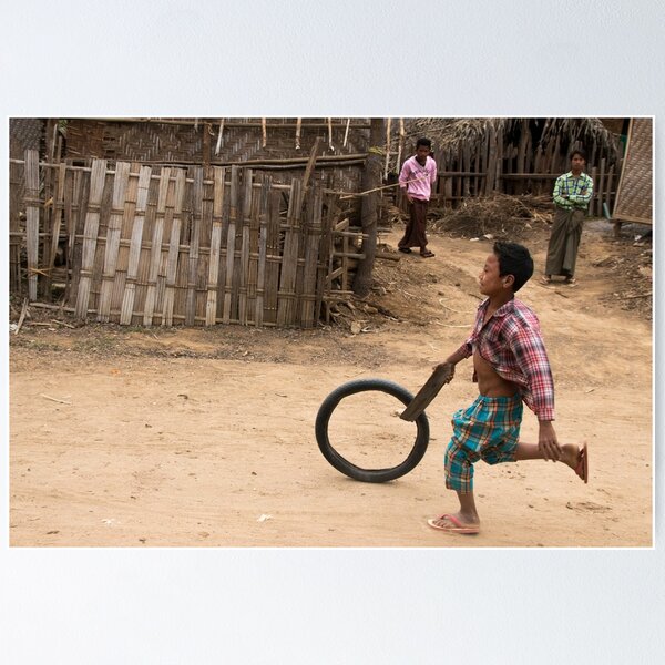 A Child Playing With A Wheel in Myanmar Poster