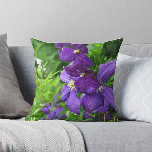 Clematis vines among wildflowers Throw Pillow