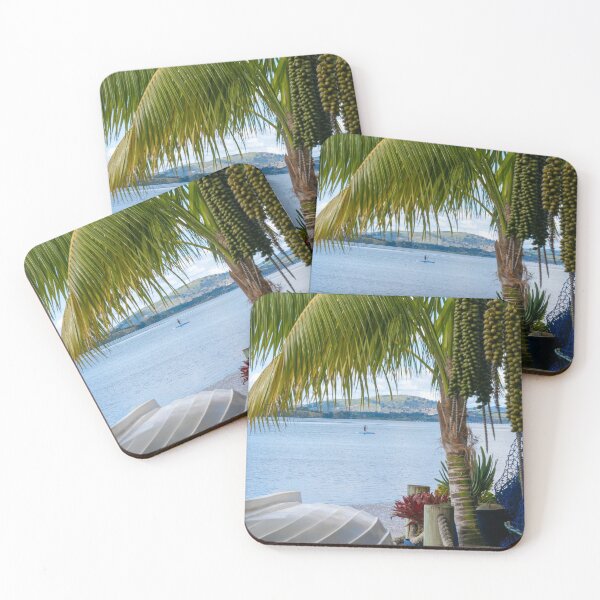 Item preview, Tropical garden frames view over white clinker dinghy to bay with stand-up paddle-boarder in distance. designed and sold by Brian Scantlebury.