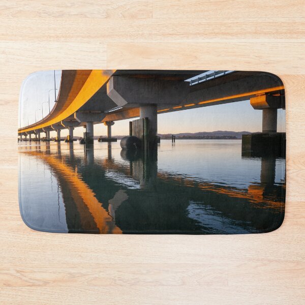Item preview, Morning sun strikes side Tauranga Harbour Bridge in golden hue reflected leading lines into calm water below  designed and sold by Brian Scantlebury.