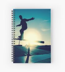 Skateboarder silhouette on a grind Spiral Notebook