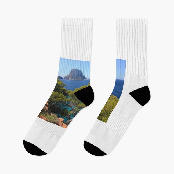 Item preview, The solitary islet of Es Vedra in contrast against the blue sea of ​​Ibiza immersed in the green and arid wild nature in Spain designed and sold by alessiapenny.