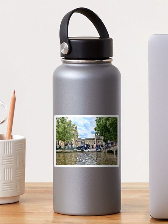 Thumbnail 1 of 3, Sticker, Japanese Akita dog in the river, Bourton-on-the-Water village designed and sold by santoshputhran.