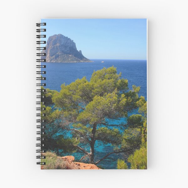 Item preview, The solitary islet of Es Vedra in contrast against the blue sea of ​​Ibiza immersed in the green and arid wild nature in Spain designed and sold by alessiapenny.