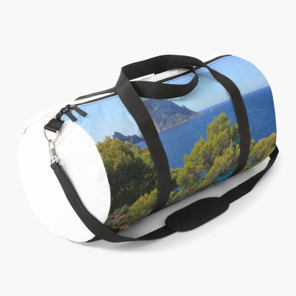 Item preview, The solitary islet of Es Vedra in contrast against the blue sea of ​​Ibiza immersed in the green and arid wild nature in Spain designed and sold by alessiapenny.