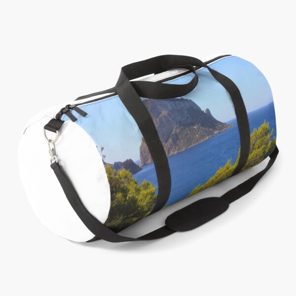 Item preview, The solitary islet of Es Vedra in contrast against the blue sea of ​​Ibiza immersed in the green and arid wild nature in Spain designed and sold by alessiapenny.