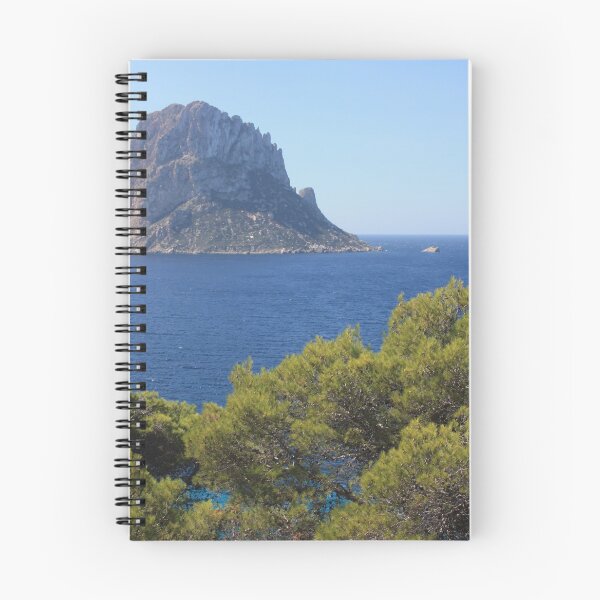 Item preview, The solitary islet of Es Vedra in contrast against the blue sea of ​​Ibiza immersed in the green and arid wild nature in Spain designed and sold by alessiapenny.