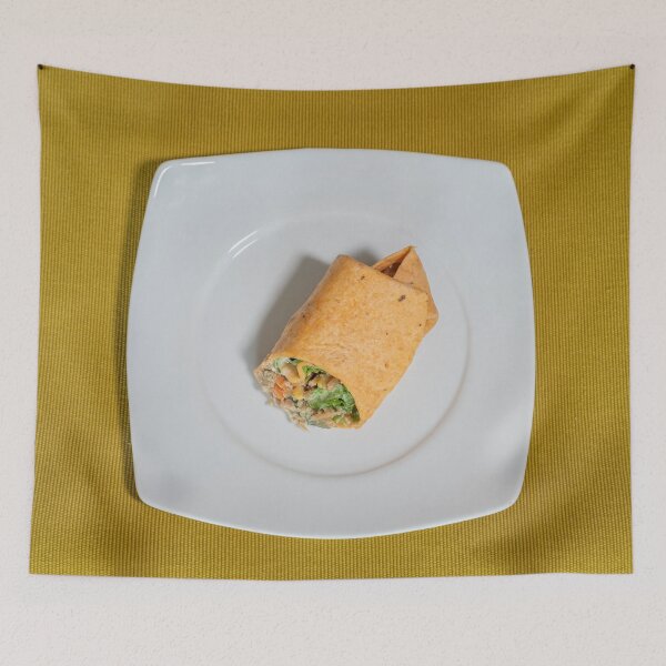 Item preview, Vegetarian wrap served on a white plate resting on a mustard-colored table runner designed and sold by brambillasimone.