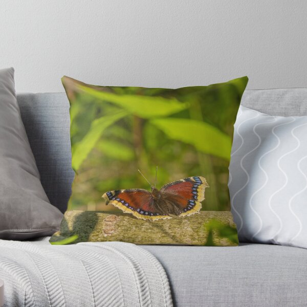 Butterfly in the forest: enchanting Mourning cloak Throw Pillow
